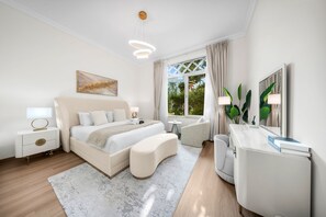 A modern bedroom with a large bed, bedside tables, a desk, and a window with curtains. - Stayshort - 2 Bed in Palm Jumeirah With Beach Access for 4 (Dubai)