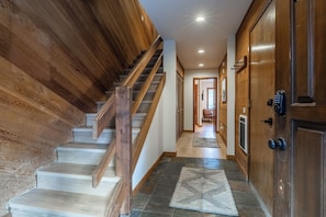 A wooden staircase leading to a landing with a door and a keypad lock. - Just Renovated & Steps to Village! 2BR/2BA + Loft (Mammoth Lakes)