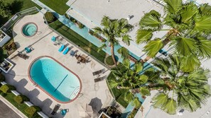 A swimming pool with sun loungers and palm trees. - Joshua Tree & Chill | Palm Springs Studio (Palm Springs)
