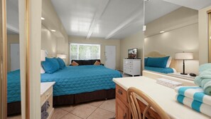 A bedroom with a bed, a desk, a chair, a dresser, and a mirror. - Joshua Tree & Chill | Palm Springs Studio (Palm Springs)