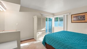 A bedroom with a bed, a wardrobe, a window, and a door leading to a balcony. - 1 Bedroom for Palm Springs Adventures (Palm Springs)