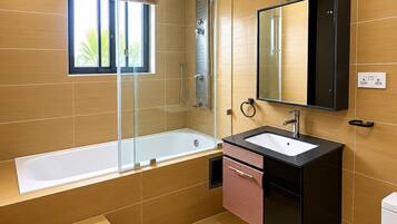 A modern bathroom with a glass-enclosed shower, a freestanding bathtub, a vanity with a mirror, and a toilet.