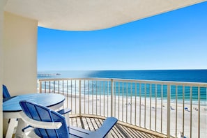 A balcony with a view of the beach and ocean. - Beachfront corner condo w direct gulf access, amazing views and ideal location (Gulf Shores)