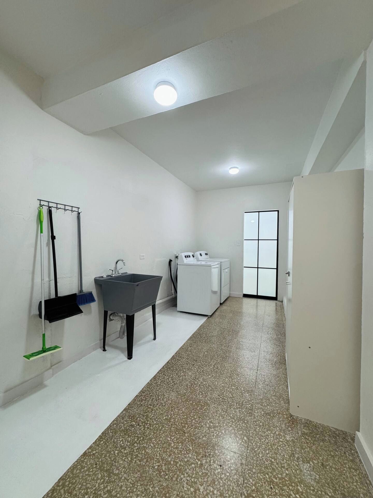A clean, modern bathroom with a sink, mirror, and a shower area.