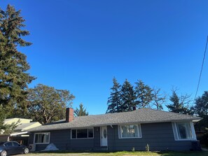 A single-story house with a grey exterior, a chimney, and a garage. - Tacoma GL (Tacoma)