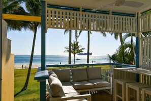 A covered outdoor seating area with a view of the beach and ocean. - Villa 42 - Tangalooma - Moreton Island (moreton island)