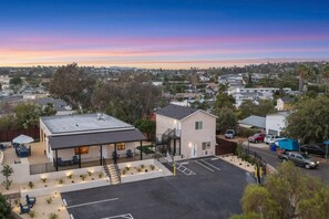 A residential area with a two-story house featuring a covered patio and a small parking lot. - Vista Compound | Walk to Downtown/Shops/Dining (Vista)