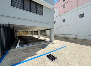 A parking area with concrete flooring and a blue line marking. - Historic San Germán Retreat + Prime Location (San Germán)