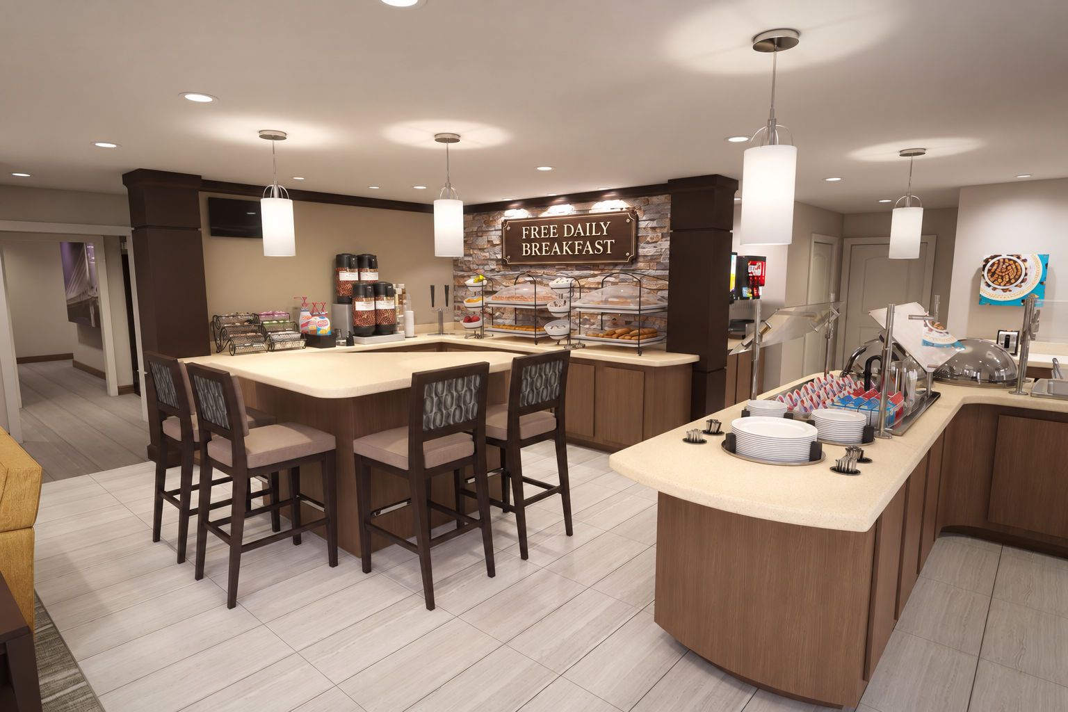 Un comptoir où est servi le petit-déjeuner, avec un panneau indiquant que le petit-déjeuner est gratuit et offert quotidiennement, ainsi qu’une variété d’aliments et un espace avec des chaises où les clients peuvent s’asseoir.