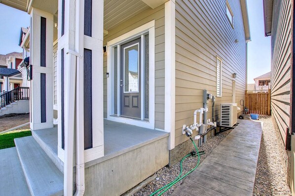 A residential property with a front porch, a garage, and a driveway.