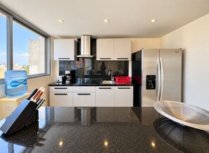 A modern kitchen with a stainless steel refrigerator, a coffee maker, and a water dispenser. - Luxury Penthouse-Private Jacuzzi -8-BR (Playa del Carmen)