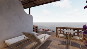 A terrace with a view of the sea, wooden furniture, and a railing. - Cardedeu Punta Elefante (Chiltiupan)
