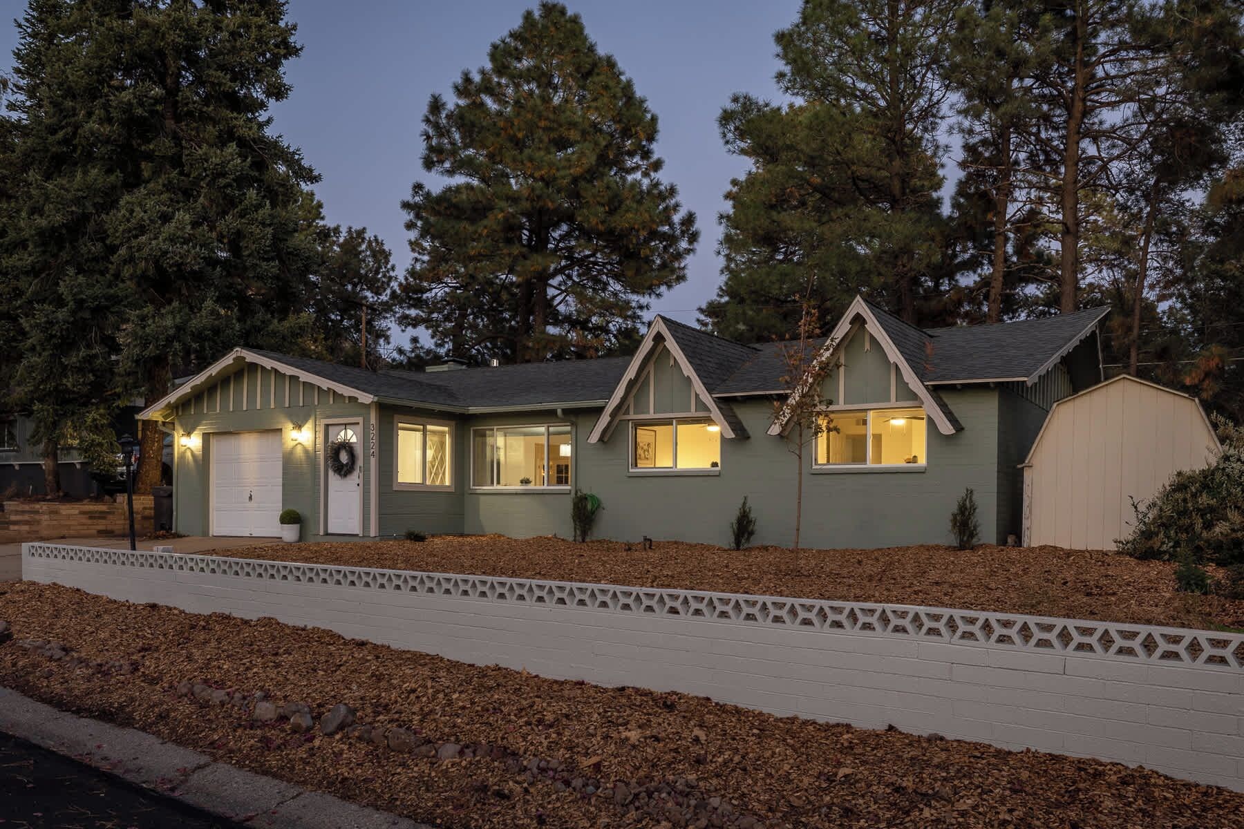 A two-story house with a garage, a front porch, and a driveway.