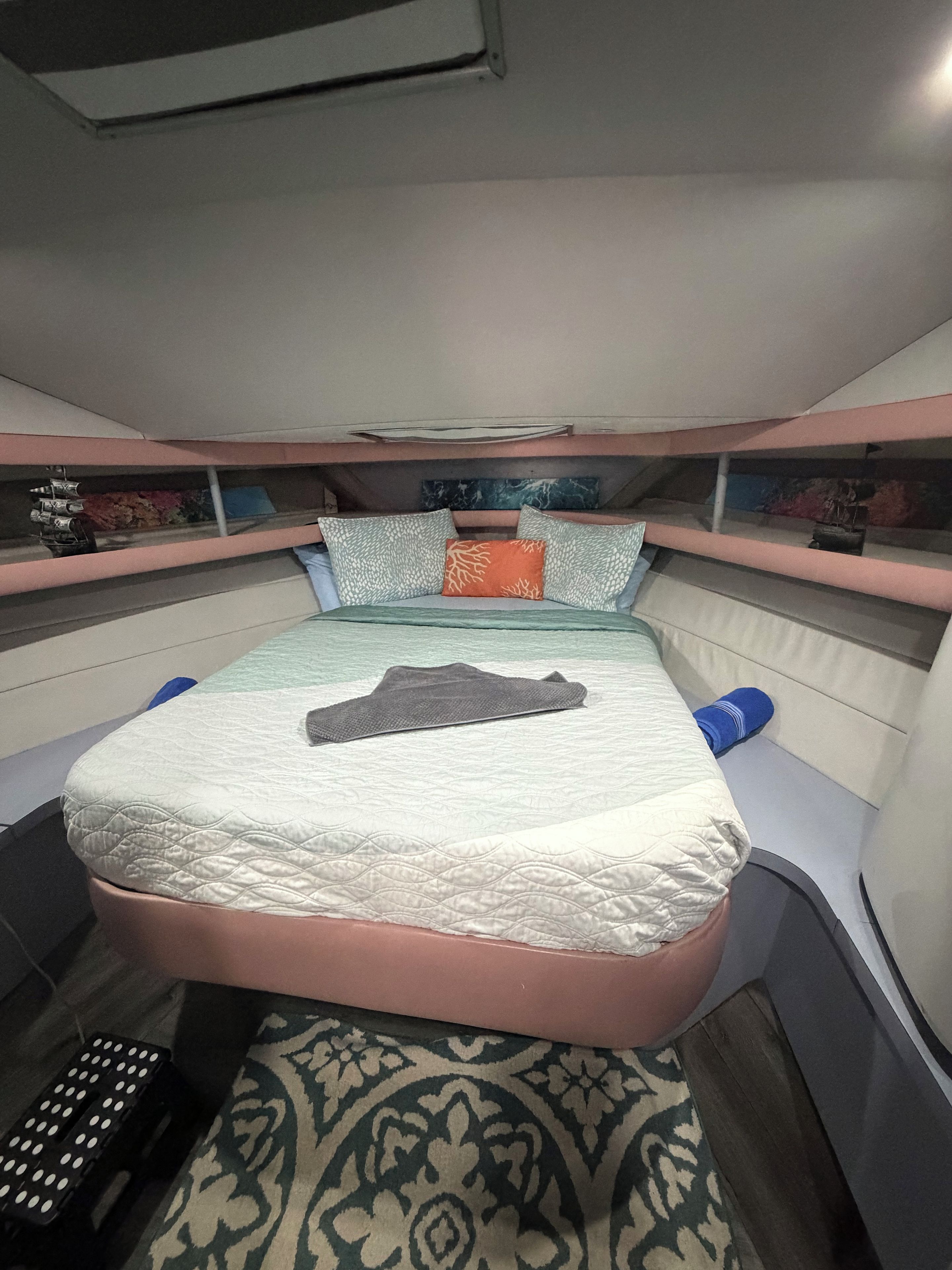 Een stapelbed met een matras, kussens, een deken en een afstandsbediening.