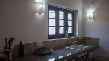A kitchen with a window, a sink, and a countertop.