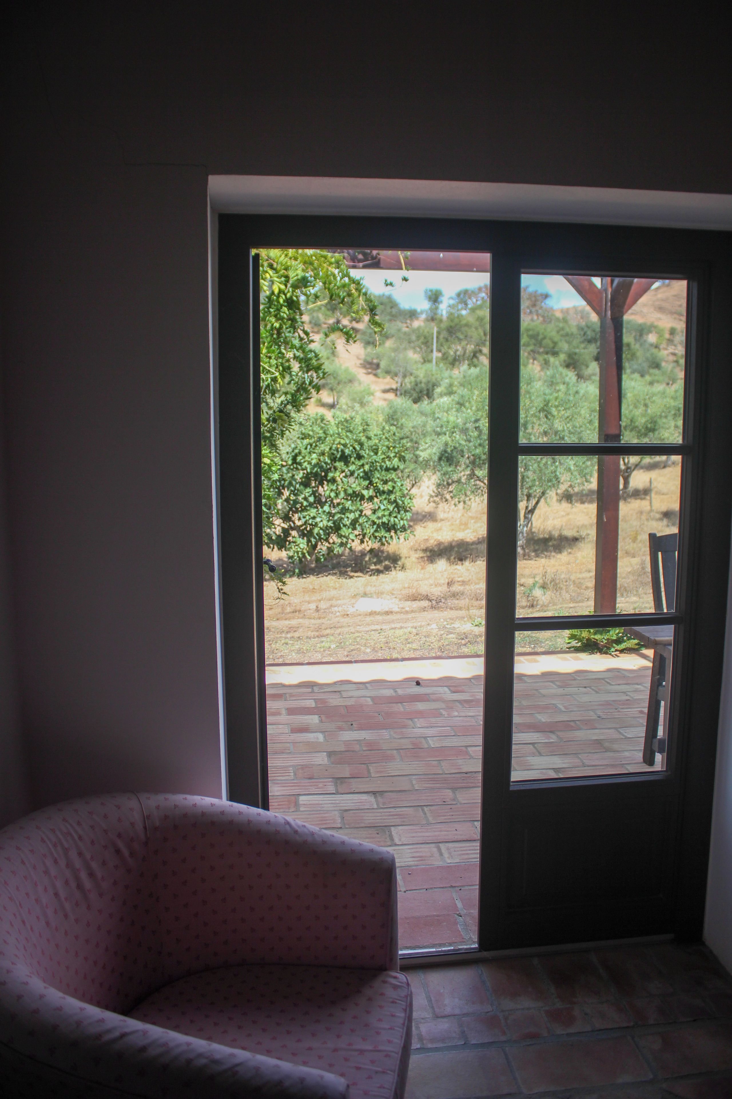 A room with a sliding glass door leading to an outdoor patio area.