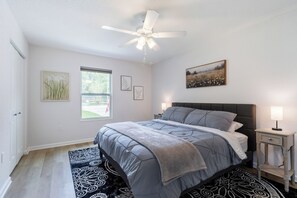 A bedroom with a bed, a ceiling fan, a window, and artwork on the walls. - ★★ Springs & Saddles ★★ 
Dunnellon Getaway Near Ocala & Rainbow Springs (Dunnellon)