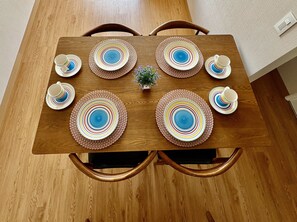 A wooden dining table with six plates and matching cups, surrounded by chairs. - Dept. Brand-New, Central, and Modern Family Home (Pet-Friendly and Free Parking) (Lima)