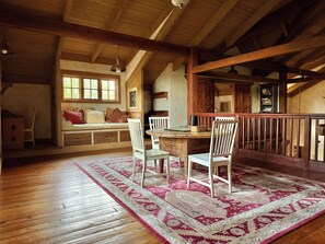 A wooden interior with a dining area, a bench, and a staircase. - Spacious and secluded ranch getaway on 200 acres (Grass Valley)