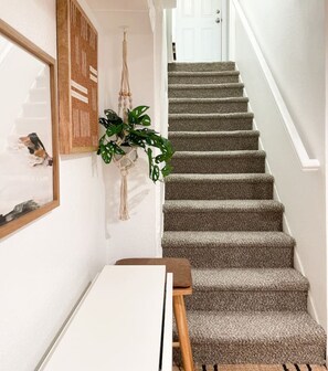A staircase with carpeted steps leading to a door. - The Mile High Haven – Arvada Getaway (Arvada)