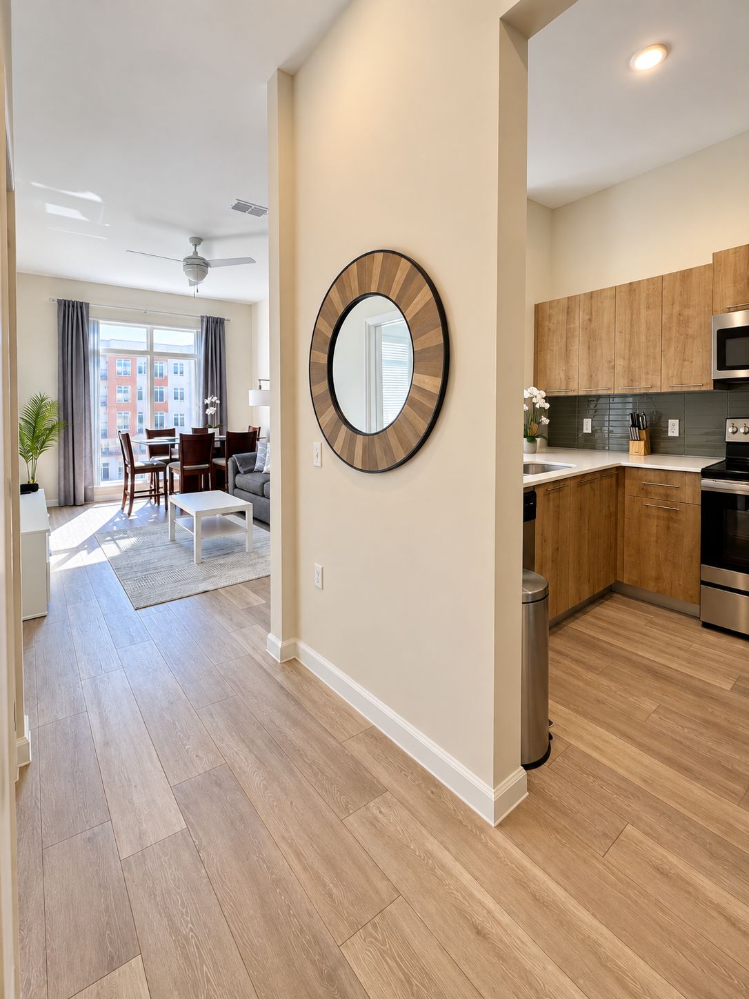 Bright modern entry with open living space and sleek wood-accent kitchen