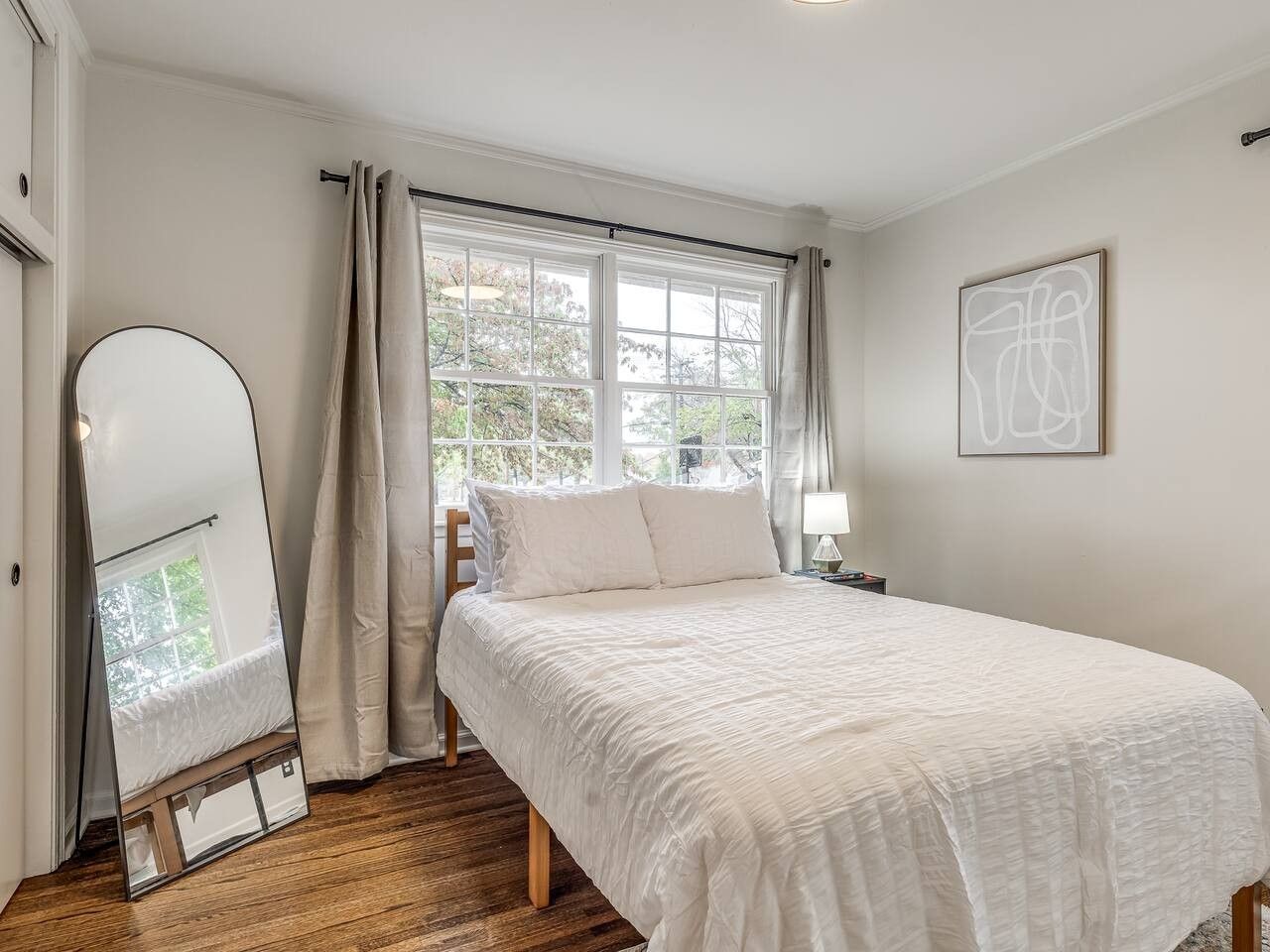 Bedroom with standing mirror