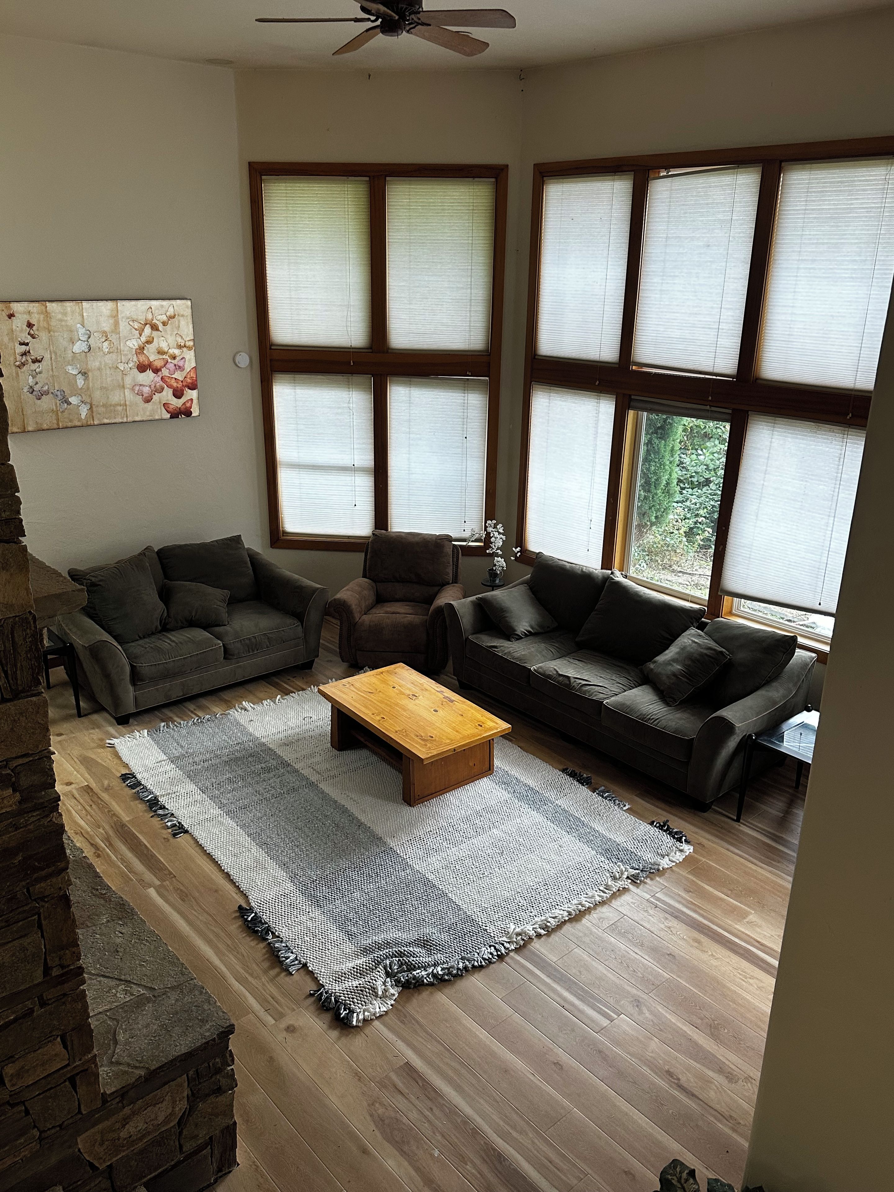 A living room with two sofas, a coffee table, and a rug.