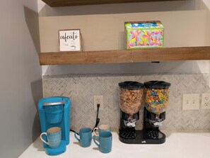 A kitchen counter with a coffee maker, two coffee mugs, cereal dispensers, and a cereal box. - Cozy Southtown nearby King Williams home. Nearby Alamodome and Frost Bank Center (San Antonio)