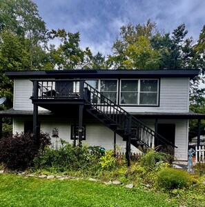 A two-story house with a balcony, a staircase, and a garden. - Peaceful Catskills Getaway - Cozy Studio Loft (Cairo)