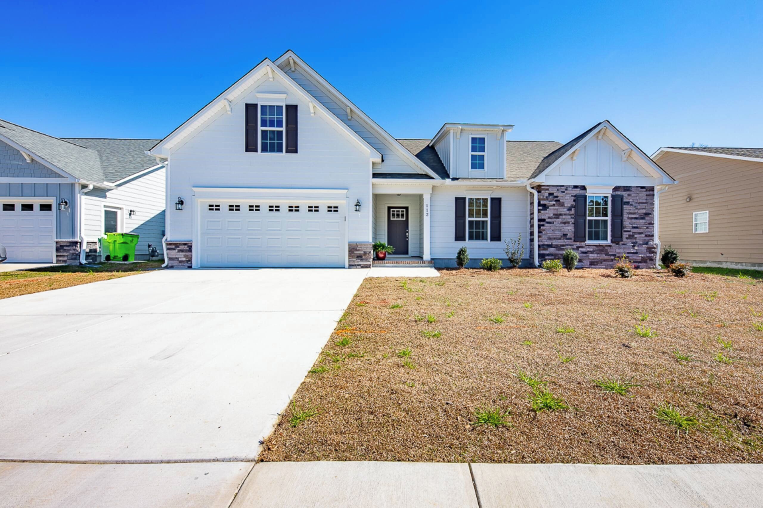 A single-story house with a garage, a front lawn, and a driveway.