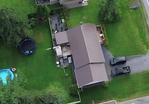 A residential property with a two-story house, a fenced yard, a trampoline, and a swimming pool. - Large 5-bedroom Home Near 401.  Ideal for Work Crews & Families. (Cornwall)