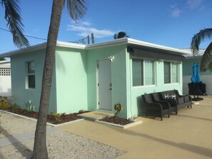 A single-story building with a flat roof, a front door, and a small porch area. - Canal Front, Ocean View, Ice Machine, 60' Prime Dockage! (Marathon)