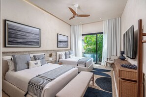 A hotel room with two beds, a ceiling fan, a large window with curtains, and a television. - Beachfront 5BR Villa w/ Pool, big garden, Ocean Views & Premier Golf Membership (Punta de Mita)