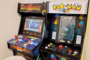 Two arcade machines, one for Mortal Kombat and one for Pac-Man, with joystick controls and game screens. - FreePoolHeat|HotTub|Sleeps18|Arcade|ThemeRooms (Mesa)
