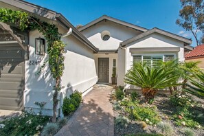A residential property with a garage, a front door, and a pathway leading to the entrance. -  Beautifully remodeled 3-bedroom home  located close to the beach in Cardiff, CA (Encinitas)