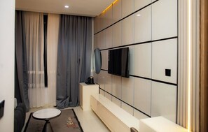 A modern bathroom with a bathtub, a toilet, a sink, and a mirror.