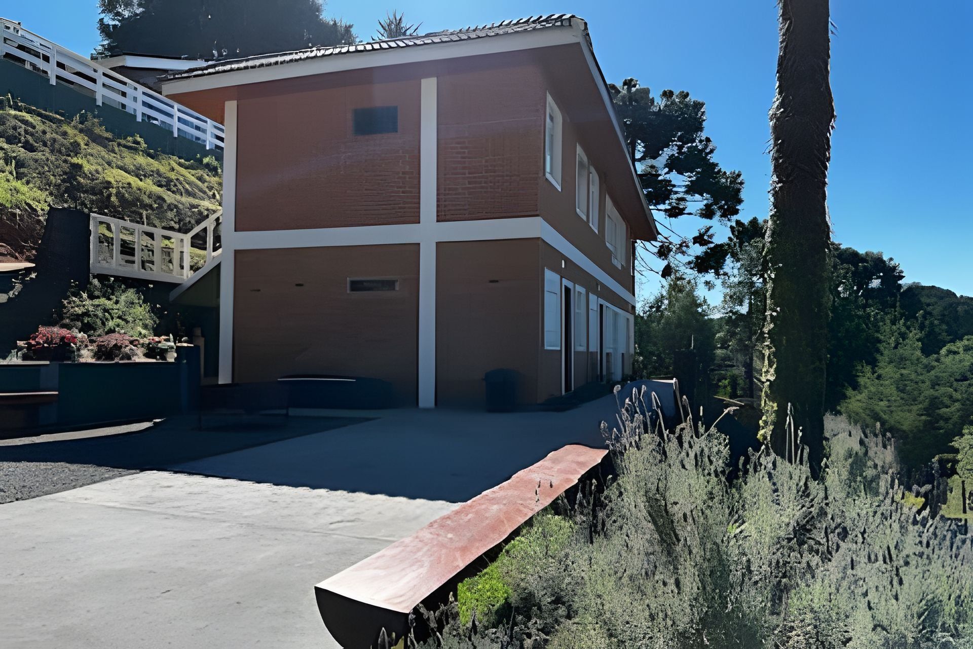 A two-story building with a flat roof and a brick facade.