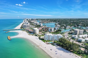 A coastal resort area with beachfront properties, a marina, and a clear view of the ocean. - Beachfront Escape in the Moorings | Gulf Views & Coastal Breeze (Naples)