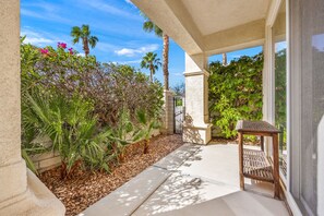 A covered outdoor area with a patio, seating, and a view of the surrounding garden. - 2 bed, 2.5 bath Oasis: Clubhouse, Pool, Gym- Steps to Polo Concerts Golf Tennis! (La Quinta)