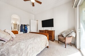 A bedroom with a bed, a dresser, a television, and a chair. - 2 bed, 2.5 bath Oasis: Clubhouse, Pool, Gym- Steps to Polo Concerts Golf Tennis! (La Quinta)