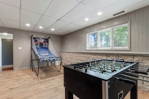 A room with a foosball table and a basketball hoop. - Hillside Haven | Beach Access, Game Room & Fire Pit (Lake Geneva)