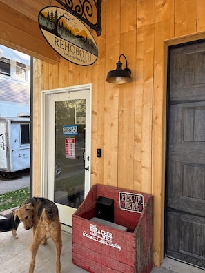 A wooden building with a sign reading 'REHOBOTH PLACE FOR REST' and a closed door with a 'PUSH' sign.