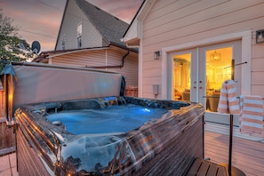 A hot tub on a wooden deck with a house in the background. - 5 Min to Lucas Oil - Hot Tub - Arcade - Outdoor Movie - Propane Firepit (Indianapolis)