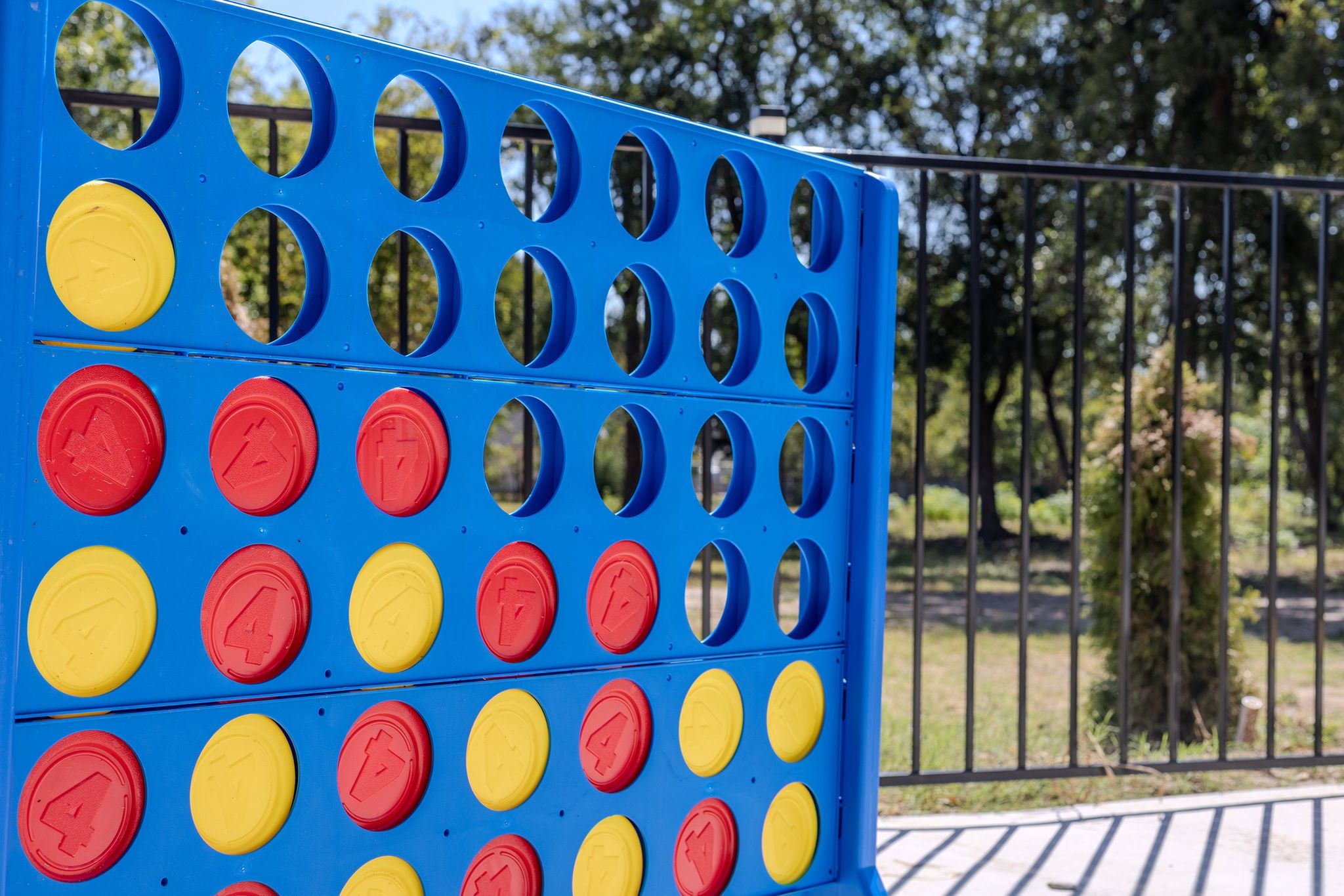 A blue and yellow play structure with circular openings and red and yellow buttons.