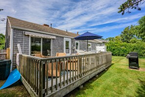 A house with a covered patio, outdoor furniture, and a grill. - Ripple Effect - near the beach and Main Street (Hyannis)