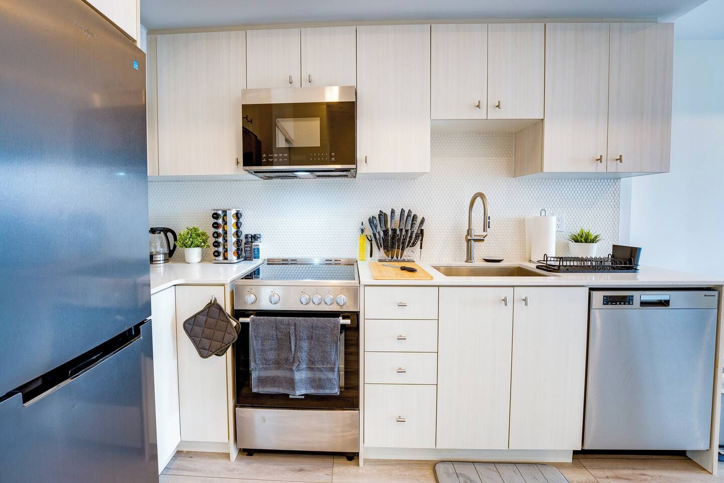 A modern kitchen with stainless steel appliances, a microwave, and a dishwasher.