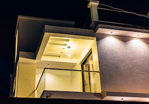 A staircase with a glass railing leading to a landing with a light fixture. - CRYSTAL APARTMENT AND GUEST HOUSE (Kigali)