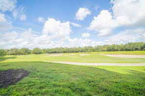 A golf course with a clear sky and lush greenery. - The Centre at Reunion-1356 (Kissimmee)