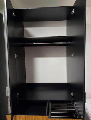 A black metal wardrobe with three shelves and a lower compartment. - Private Mini Loft in southern Mexico City, near C.U. (Ciudad de México)