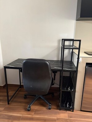 A workspace with a desk, chair, and shelving unit. - Private Mini Loft in southern Mexico City, near C.U. (Ciudad de México)
